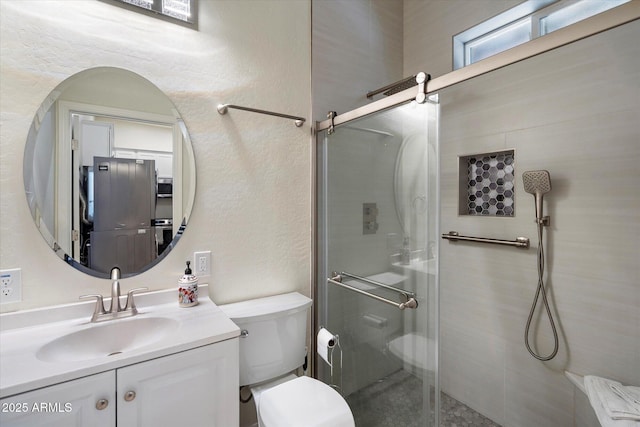 12943 W Mclellan Rd, Glendale, AZ 85307 - bathroom with toilet, a stall shower, a textured wall, and vanity