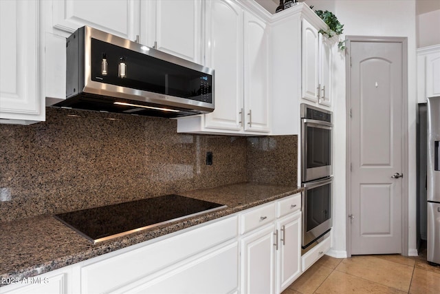 12943 W Mclellan Rd, Glendale, AZ 85307 - kitchen featuring tasteful backsplash, white cabinets, light tile patterned floors, and appliances with stainless steel finishes