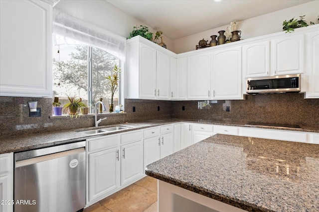 12943 W Mclellan Rd, Glendale, AZ 85307 - kitchen featuring dark stone counters, a sink, stainless steel appliances, decorative backsplash, and white cabinets