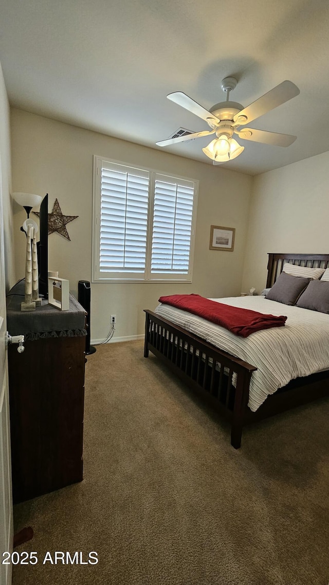 carpeted bedroom with a ceiling fan and visible vents