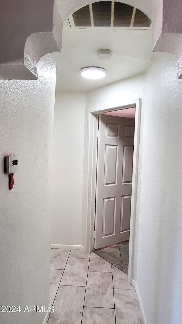 corridor featuring light tile patterned flooring