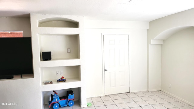 bedroom with light tile patterned floors