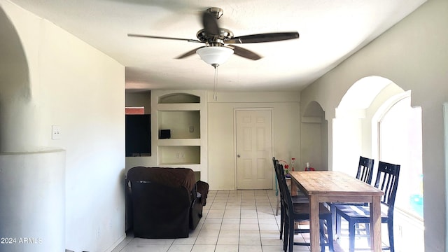 dining area with light tile patterned flooring and a ceiling fan