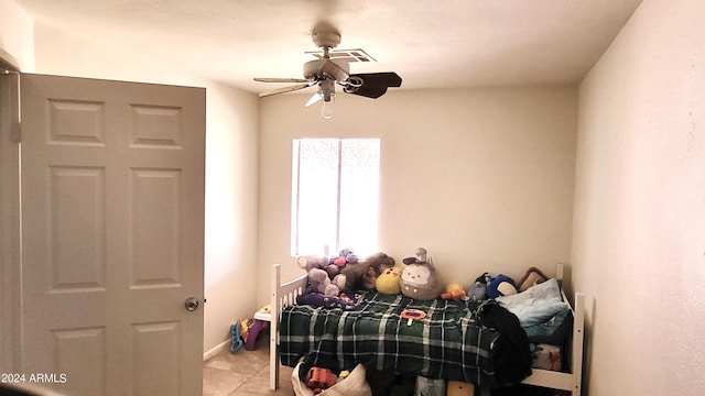 bedroom featuring light tile patterned floors and ceiling fan