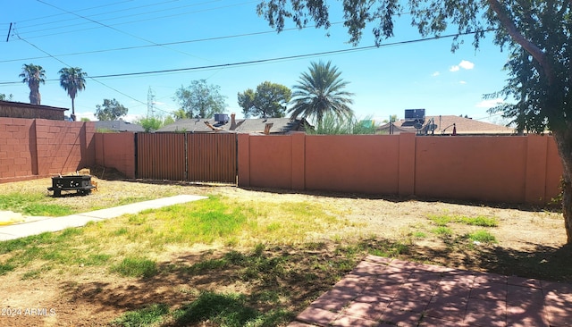 view of yard with a gate and a fenced backyard