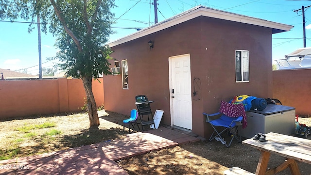 view of outbuilding featuring fence