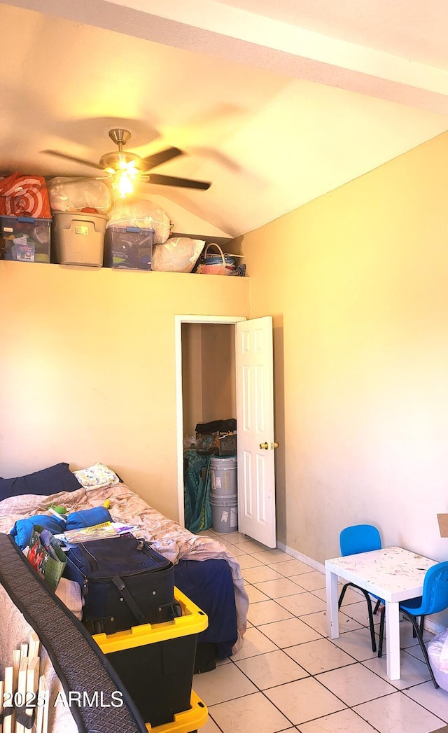 bedroom with light tile patterned floors, baseboards, and vaulted ceiling