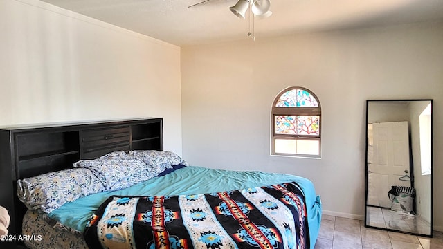 bedroom with tile patterned floors, baseboards, and a ceiling fan