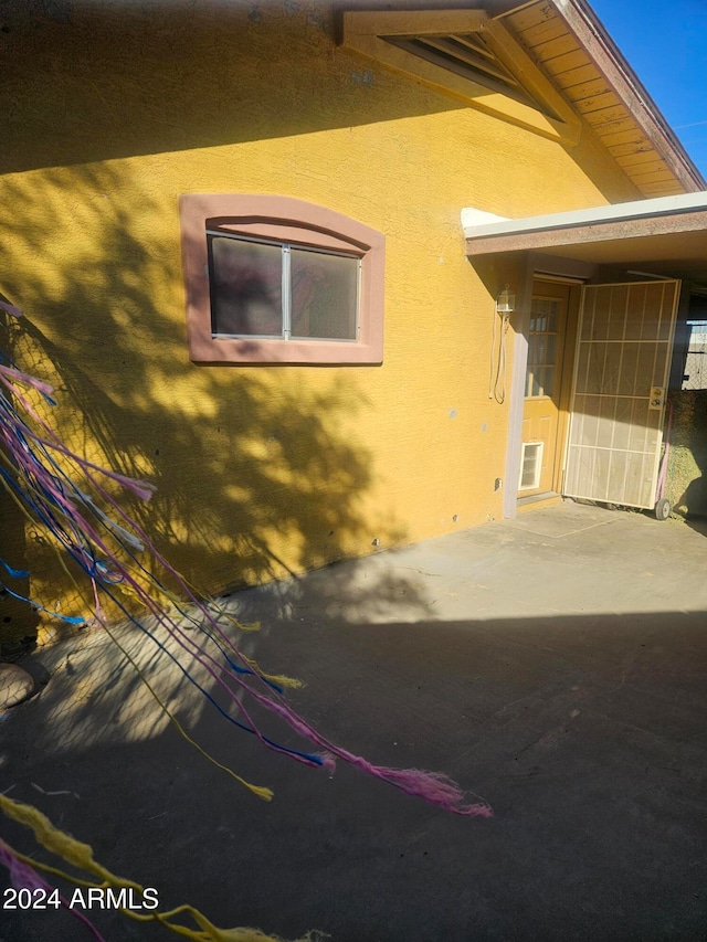 view of side of property with a patio