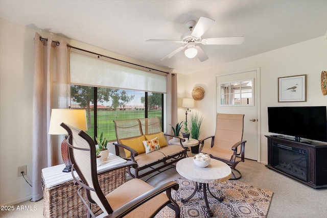 living room with a ceiling fan and light carpet