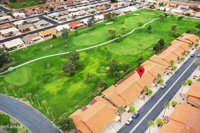 drone / aerial view with golf course view and a residential view