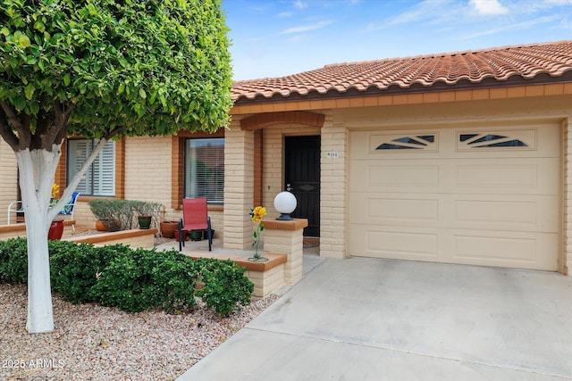 view of front of home with a tiled roof, brick siding, a garage, and driveway