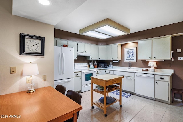 kitchen featuring a sink, under cabinet range hood, white appliances, light countertops, and light tile patterned floors