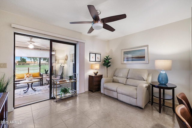 living area with ceiling fan and tile patterned flooring