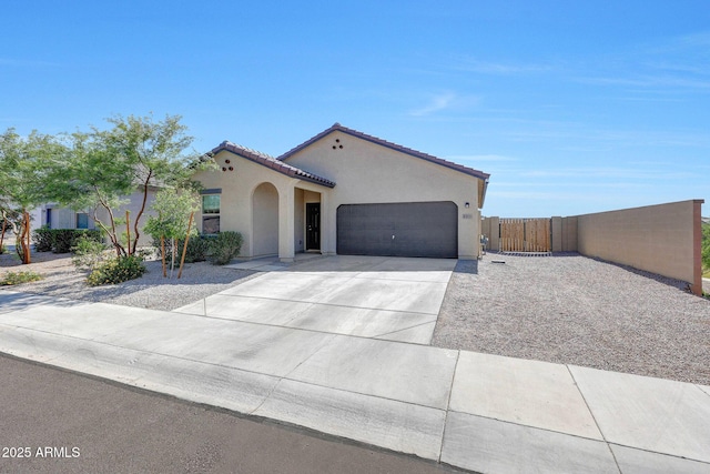 4911 N 193rd Ave, Litchfield Park, AZ 85340 - mediterranean / spanish home with stucco siding, a garage, concrete driveway, a tiled roof, and a gate