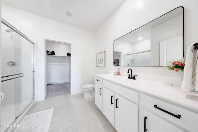 4911 N 193rd Ave, Litchfield Park, AZ 85340 - bathroom with vanity, a stall shower, toilet, and a spacious closet