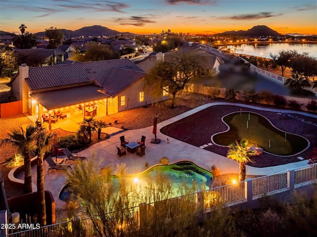 view of pool featuring a patio, a fenced backyard, a water and mountain view, and a fenced in pool