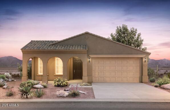 view of front of property featuring a garage, concrete driveway, a mountain view, and stucco siding