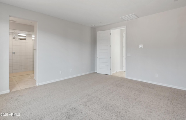 unfurnished bedroom featuring carpet floors, baseboards, ensuite bath, and visible vents