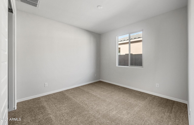 carpeted empty room featuring baseboards and visible vents