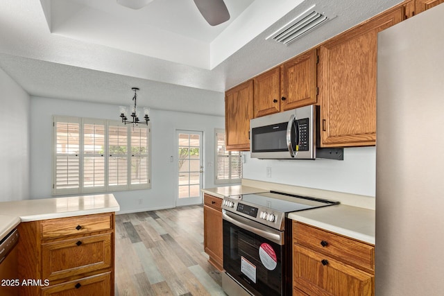 9845 W Behrend Dr, Peoria, AZ 85382 - kitchen featuring visible vents, light countertops, light wood-style floors, and stainless steel appliances