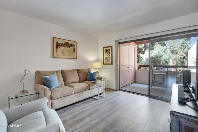 living area with wood finished floors and baseboards