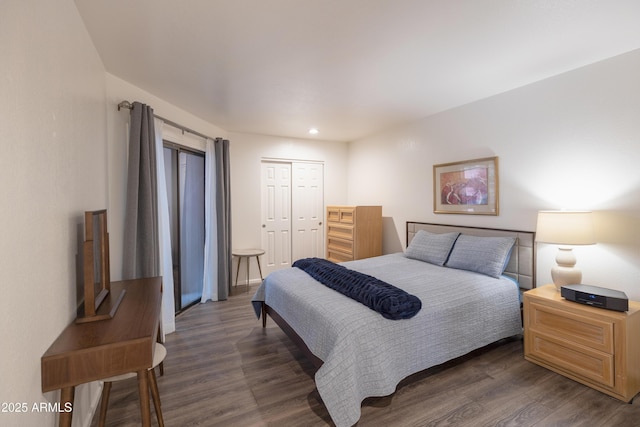 bedroom with dark wood finished floors, recessed lighting, and a closet