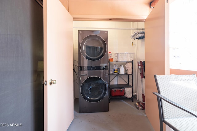 laundry area featuring stacked washer / dryer and laundry area