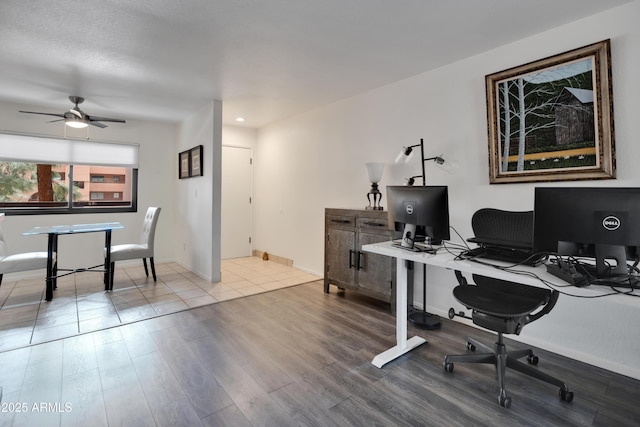 home office featuring wood finished floors, baseboards, and ceiling fan