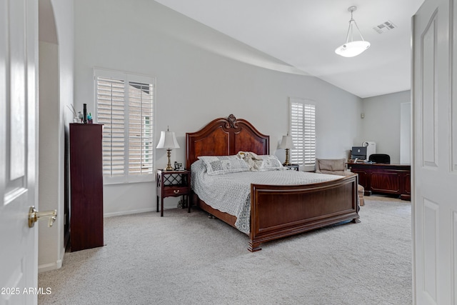 bedroom with multiple windows, carpet, and vaulted ceiling