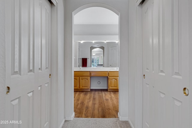 hall featuring light hardwood / wood-style flooring and sink