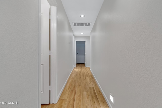 corridor with light wood-type flooring