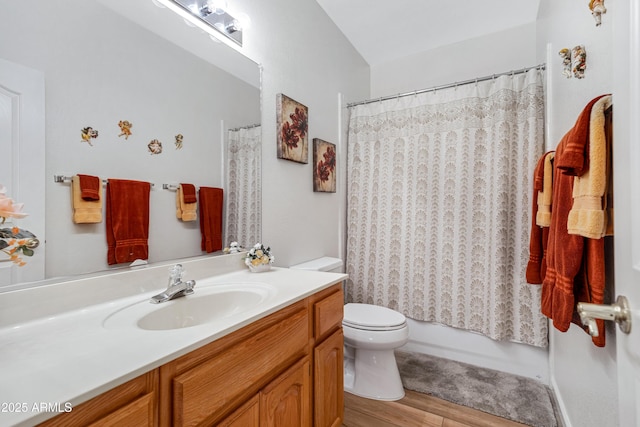 full bathroom featuring shower / tub combo with curtain, vanity, wood-type flooring, and toilet