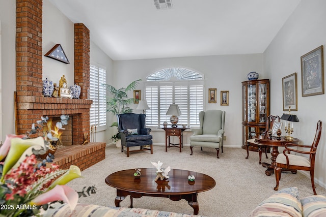 carpeted living room with a fireplace and vaulted ceiling