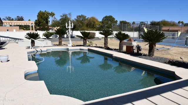 view of swimming pool with tennis court