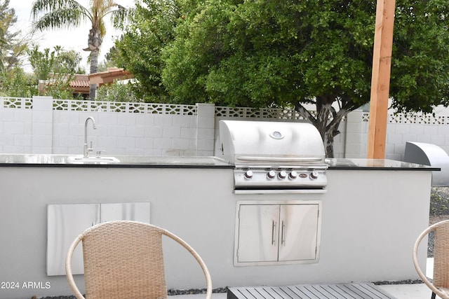 view of patio / terrace featuring area for grilling, sink, and exterior kitchen