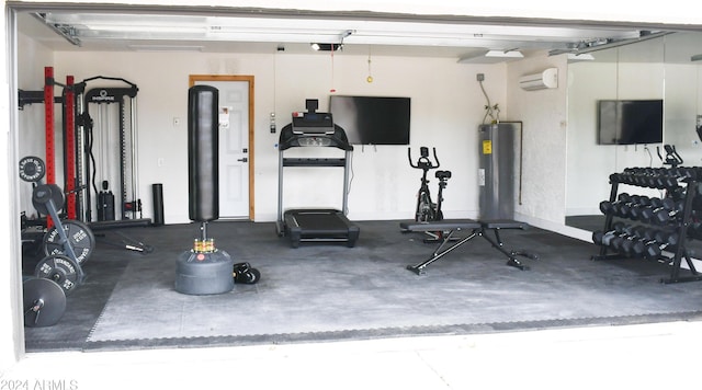 gym featuring a wall unit AC and electric water heater