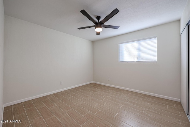 unfurnished room with ceiling fan