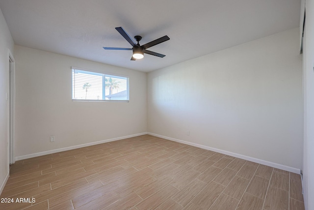 unfurnished room with ceiling fan and light wood-type flooring