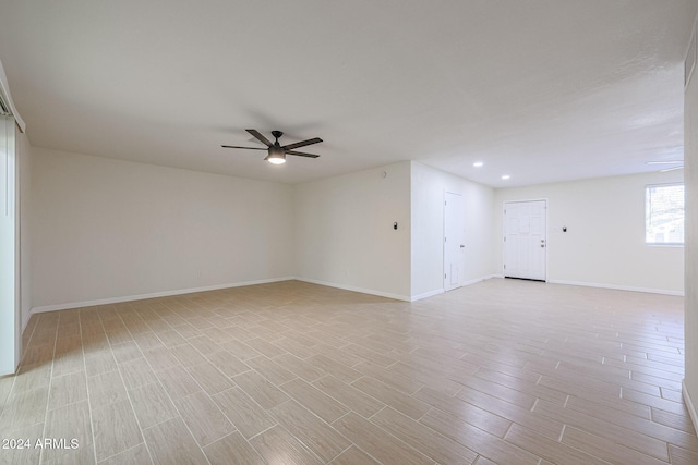 spare room with ceiling fan and light hardwood / wood-style flooring