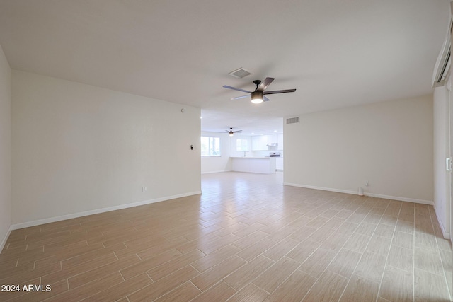 unfurnished room featuring light hardwood / wood-style flooring and ceiling fan