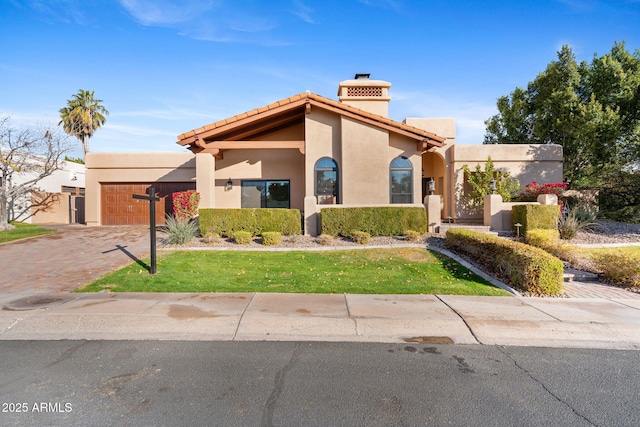 view of front facade with a garage and a front yard