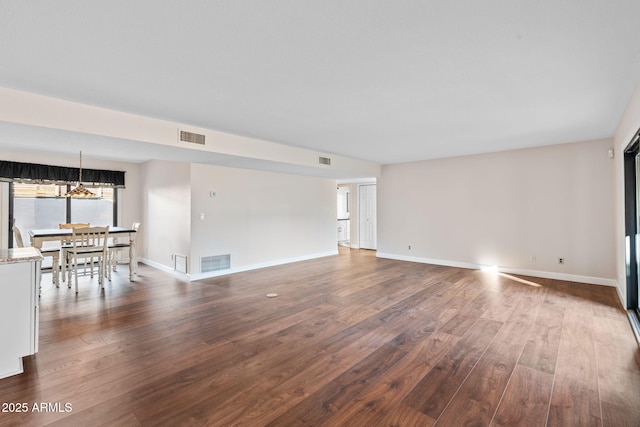 unfurnished living room featuring dark hardwood / wood-style flooring