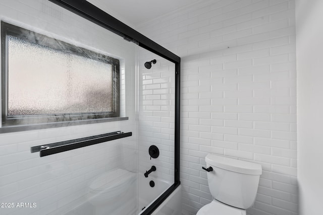 bathroom with enclosed tub / shower combo and toilet