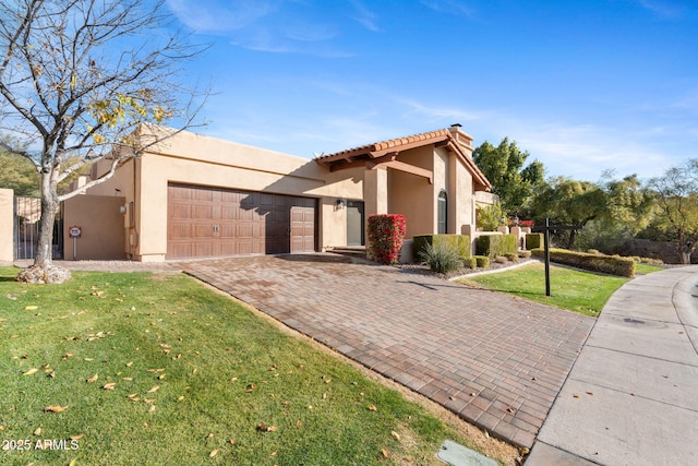 view of front of home with a garage and a front yard