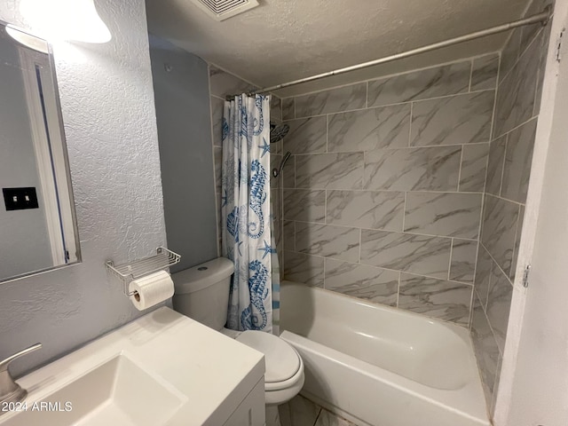 full bathroom featuring shower / tub combo with curtain, vanity, a textured ceiling, and toilet