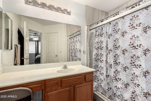 bathroom with ceiling fan, walk in shower, and vanity