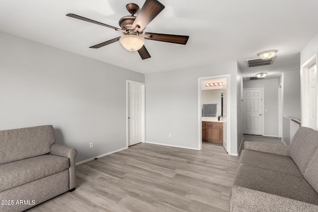 living area with ceiling fan and light wood-type flooring