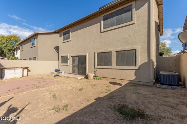 back of property featuring central AC unit