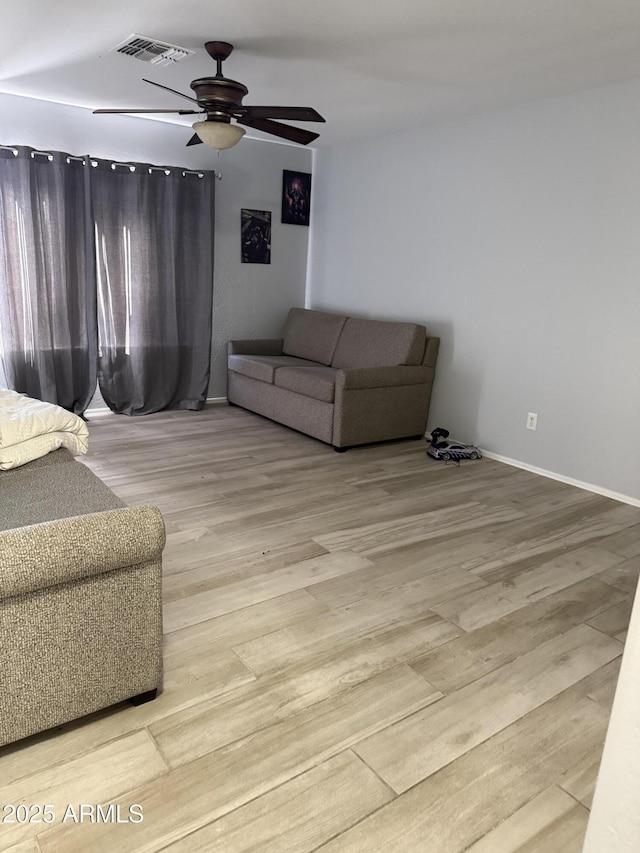 living room with ceiling fan and light hardwood / wood-style floors